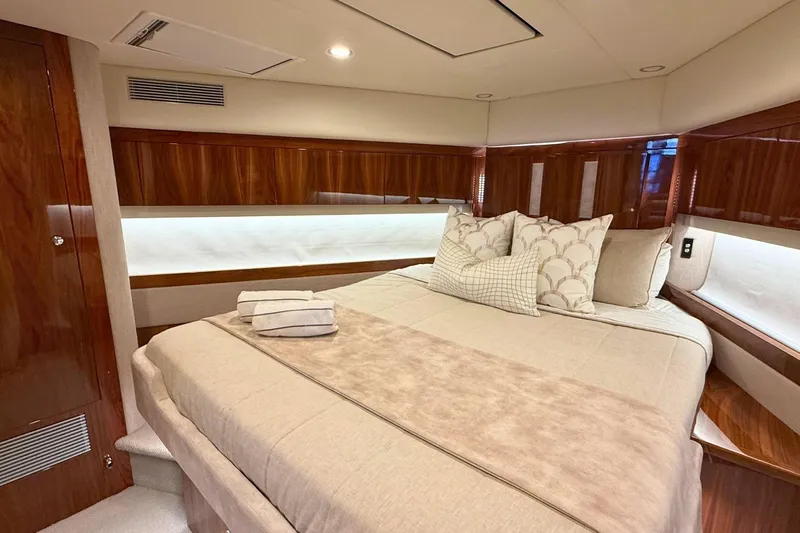 Buzz Yacht Photos Pics Luxurious bedroom interior of 2020 Riviera 57 Enclosed Flybridge yacht.