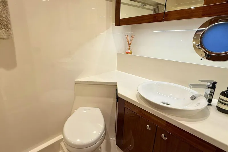 Buzz Yacht Photos Pics Luxurious bathroom in 2020 Riviera 57 Enclosed Flybridge yacht with modern fixtures.