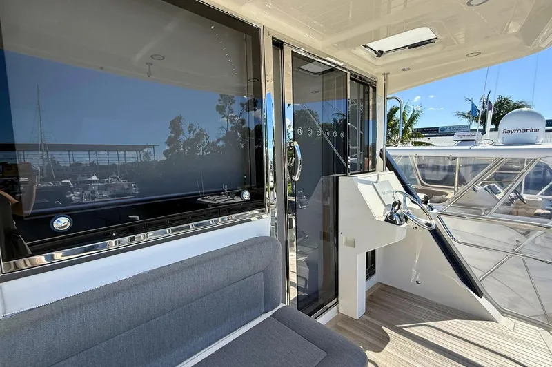 Buzz Yacht Photos Pics 2020 Riviera 57 Enclosed Flybridge yacht interior with seating and navigation equipment.