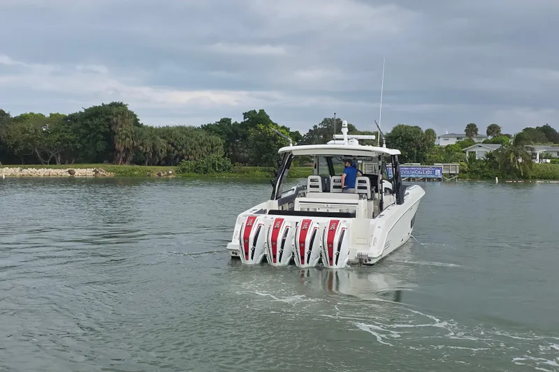 Bft Yacht Photos Pics 2021 Boston Whaler 420OR boat with four engines cruising on a calm waterway.