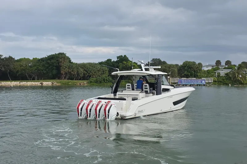 Bft Yacht Photos Pics 2021 Boston Whaler 420OR boat with multiple engines cruising on a calm waterway.