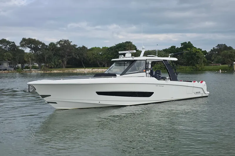 Bft Yacht Photos Pics 2021 Boston Whaler 420OR boat on calm water with lush green background.