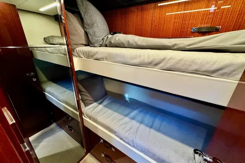  Yacht Photos Pics Luxurious bunk beds in 2021 Riva 56' Rivale yacht cabin, featuring elegant wood paneling.