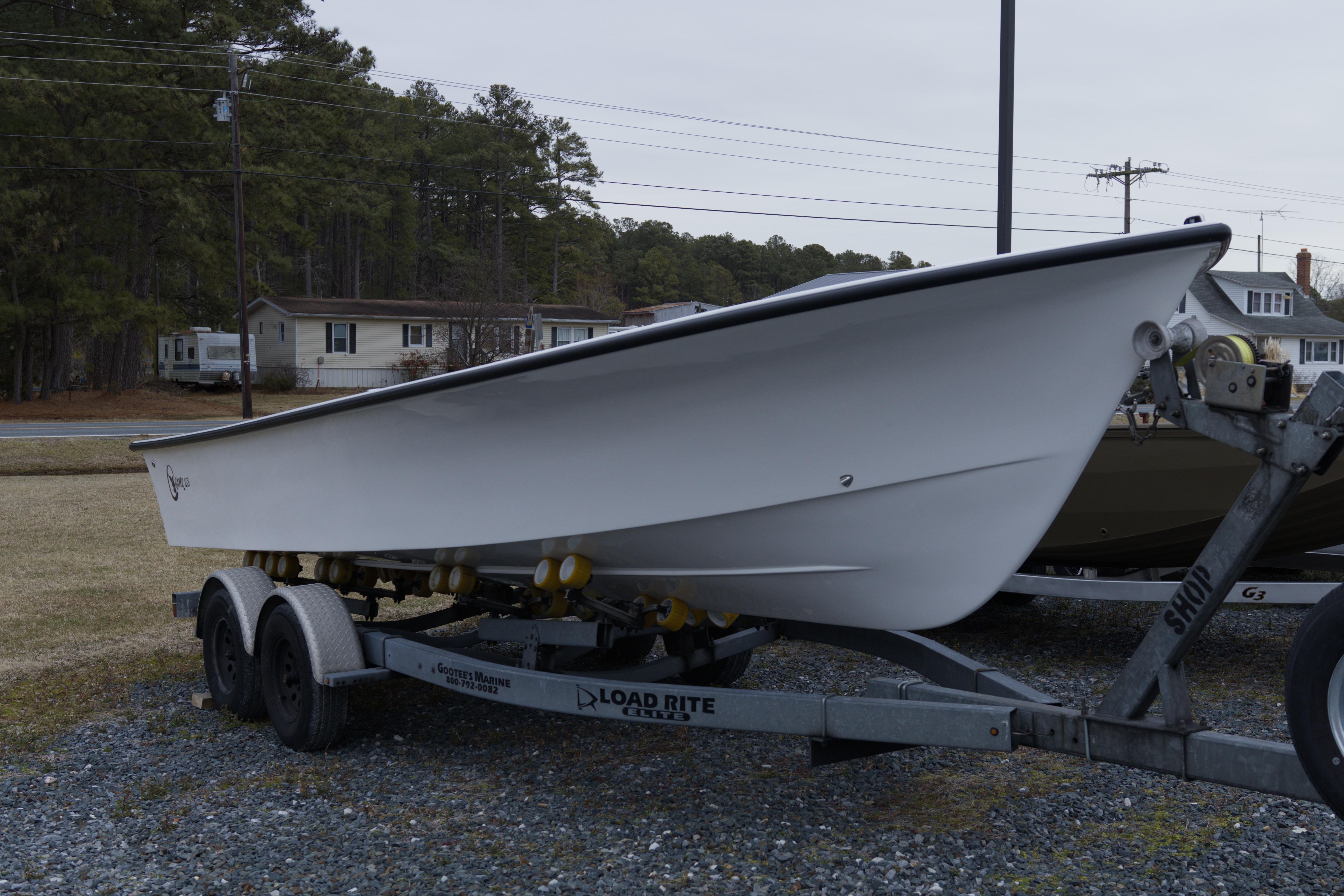 2026 C-Hawk 23 Commercial boat on trailer, parked outdoors.