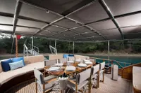 Luxurious dining area on Aganlar Custom Motorsailer Gulet, 2003, with elegant table setting and canopy.