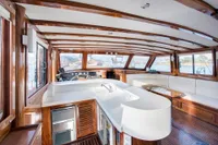 Luxurious interior of 2003 Aganlar Custom Motorsailer Gulet with wooden finishes and panoramic windows.