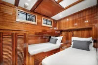 Luxurious wooden cabin interior of 2003 Aganlar Custom Motorsailer Gulet with twin beds.
