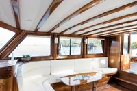 Luxurious interior of 2003 Aganlar Custom Motorsailer Gulet with elegant wood and white seating.