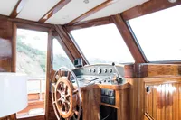 Helm of 2003 Aganlar Custom Motorsailer Gulet with wooden interior and steering wheel.