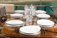 Elegant dining setup on Aganlar Custom Motorsailer Gulet, 2003, with plates and glassware.
