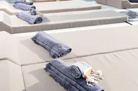 Sunbathing deck on 2003 Aganlar Custom Motorsailer Gulet with towels, overlooking serene waters.