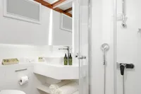 Luxurious bathroom on 2003 Aganlar Custom Motorsailer Gulet with modern shower and wooden flooring.