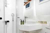 Luxurious bathroom on 2003 Aganlar Custom Motorsailer Gulet with modern fixtures and wooden flooring.