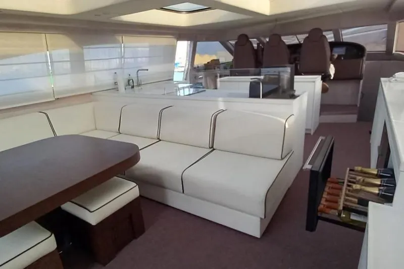  Yacht Photos Pics Luxurious yacht interior with white seating, dining table, and wine storage, AB 88 model, 2005.