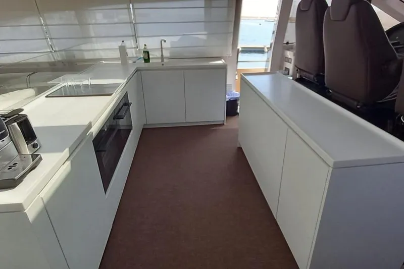  Yacht Photos Pics Modern yacht kitchen interior with white cabinetry and appliances, AB 88 model, 2005.