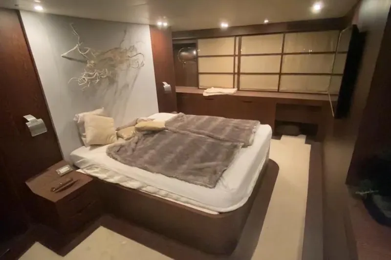  Yacht Photos Pics Luxurious bedroom interior in AB 88 yacht, 2005 model, featuring elegant decor and ambient lighting.