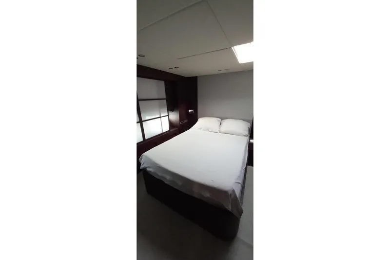  Yacht Photos Pics Luxurious bedroom interior in 2005 AB 88 yacht, featuring a comfortable double bed.