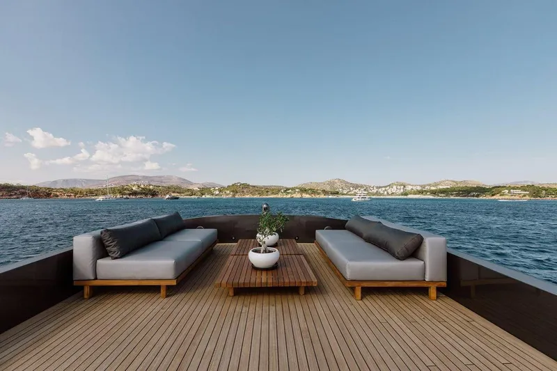Eva Yacht Photos Pics Luxurious Tecnomar Velvet 36 EVA yacht deck with sofas, sea view, and clear sky.