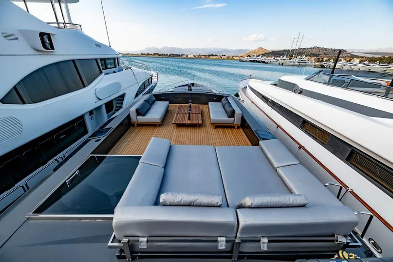 Eva Yacht Photos Pics Luxurious Tecnomar Velvet 36 EVA yacht deck with modern seating, docked in a serene marina.
