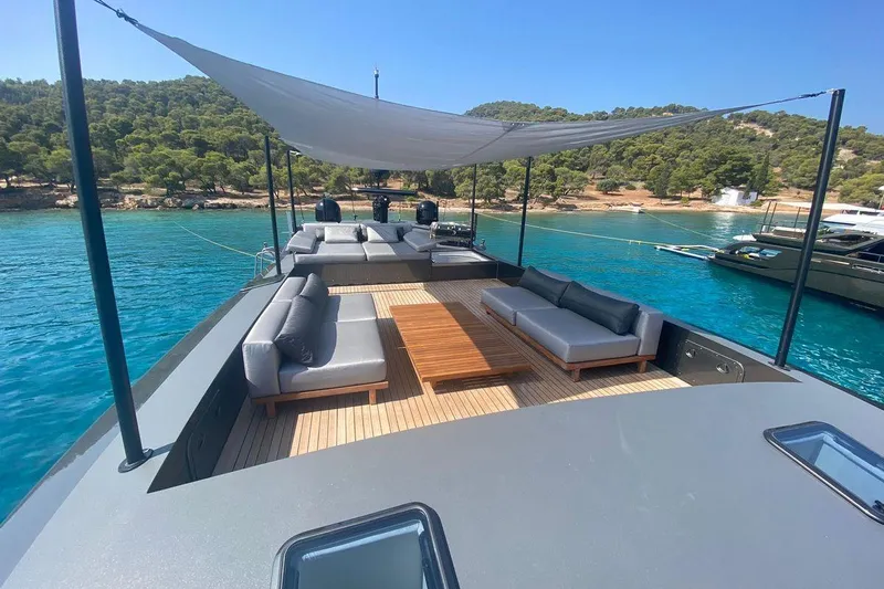 Eva Yacht Photos Pics Luxurious Tecnomar Velvet 36 EVA yacht deck with modern seating, 2009 model, anchored in serene waters.