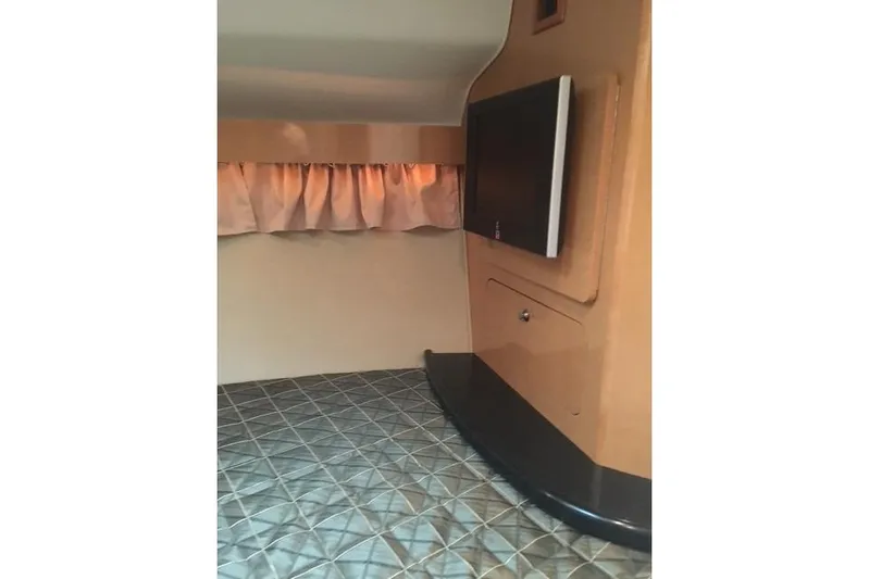  Yacht Photos Pics Interior cabin of 2010 Rinker 400 Express Cruiser with TV and bed.
