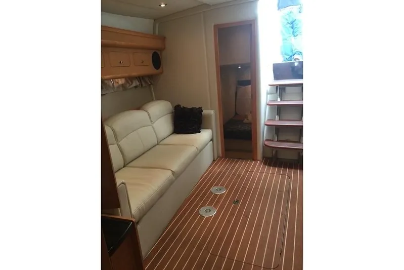  Yacht Photos Pics Interior of 2010 Rinker 400 Express Cruiser with sofa and wooden flooring.
