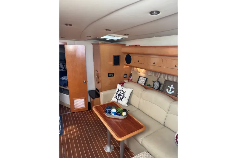  Yacht Photos Pics Interior of 2010 Rinker 400 Express Cruiser with beige seating and nautical decor.