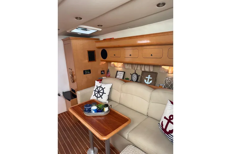  Yacht Photos Pics Interior of 2010 Rinker 400 Express Cruiser with nautical-themed decor and wooden cabinetry.