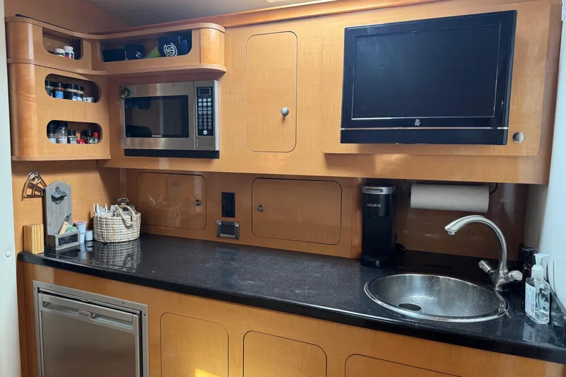  Yacht Photos Pics 2010 Rinker 400 Express Cruiser kitchen with microwave, sink, and TV.
