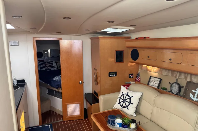  Yacht Photos Pics Interior of 2010 Rinker 400 Express Cruiser with cozy seating and nautical decor.
