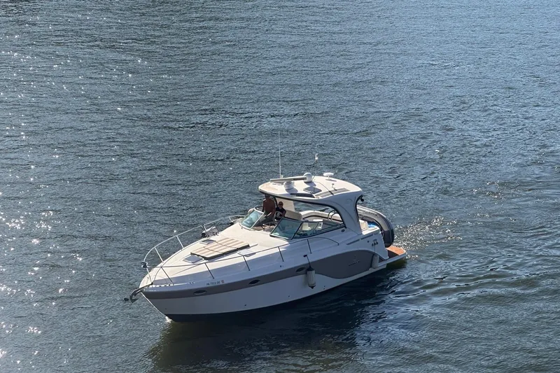  Yacht Photos Pics 2010 Rinker 400 Express Cruiser on calm water, sunny day.