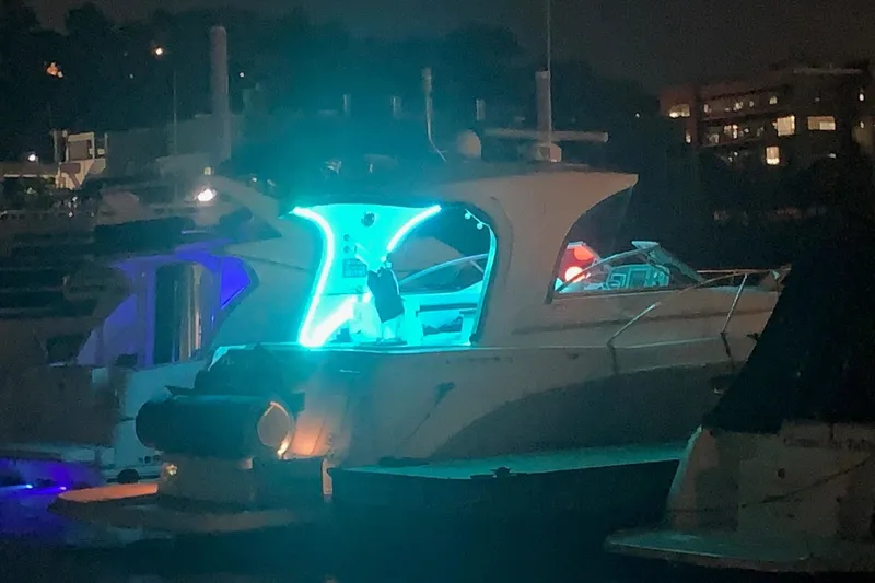  Yacht Photos Pics 2010 Rinker 400 Express Cruiser illuminated at night in a marina setting.