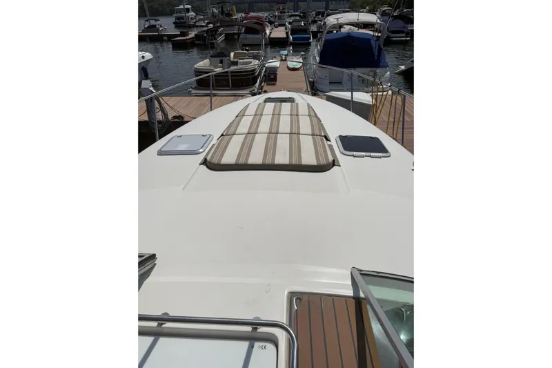  Yacht Photos Pics 2010 Rinker 400 Express Cruiser docked at marina, view from bow.