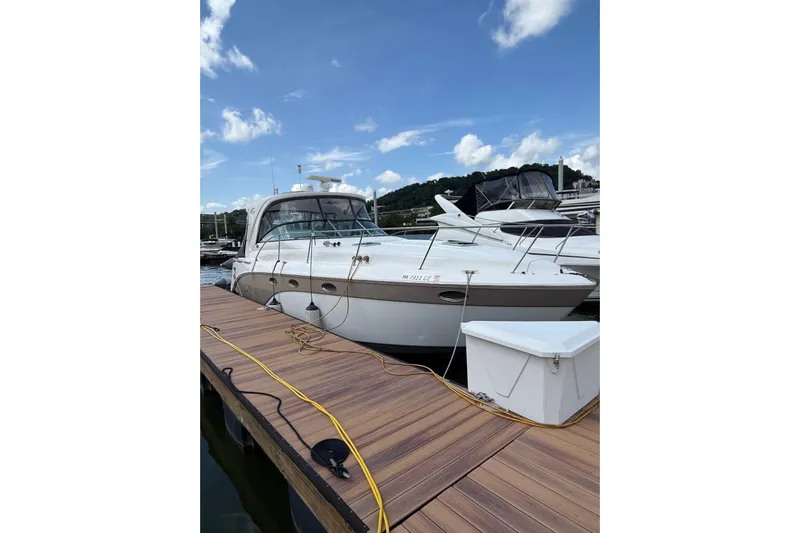  Yacht Photos Pics 2010 Rinker 400 Express Cruiser docked at marina under blue sky.