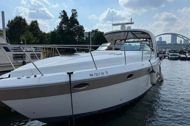  Yacht Photos Pics 2010 Rinker 400 Express Cruiser docked in a marina, under a partly cloudy sky.