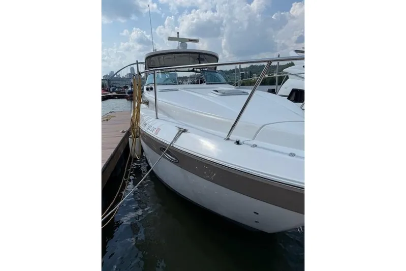  Yacht Photos Pics 2010 Rinker 400 Express Cruiser docked at marina under cloudy sky.