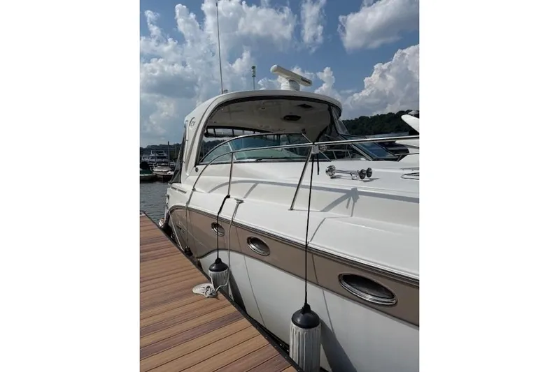  Yacht Photos Pics 2010 Rinker 400 Express Cruiser docked under a partly cloudy sky.