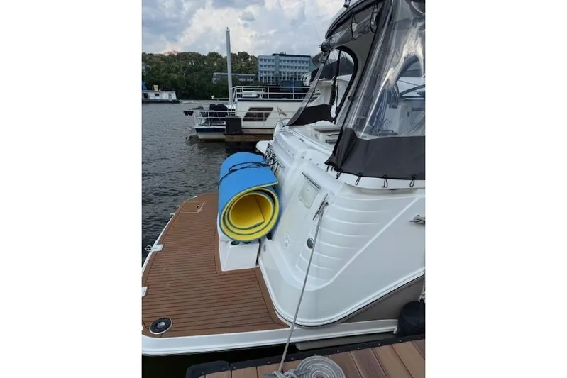  Yacht Photos Pics 2010 Rinker 400 Express Cruiser docked with rolled mats on deck.