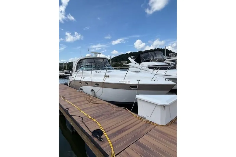  Yacht Photos Pics 2010 Rinker 400 Express Cruiser docked at marina under blue sky.