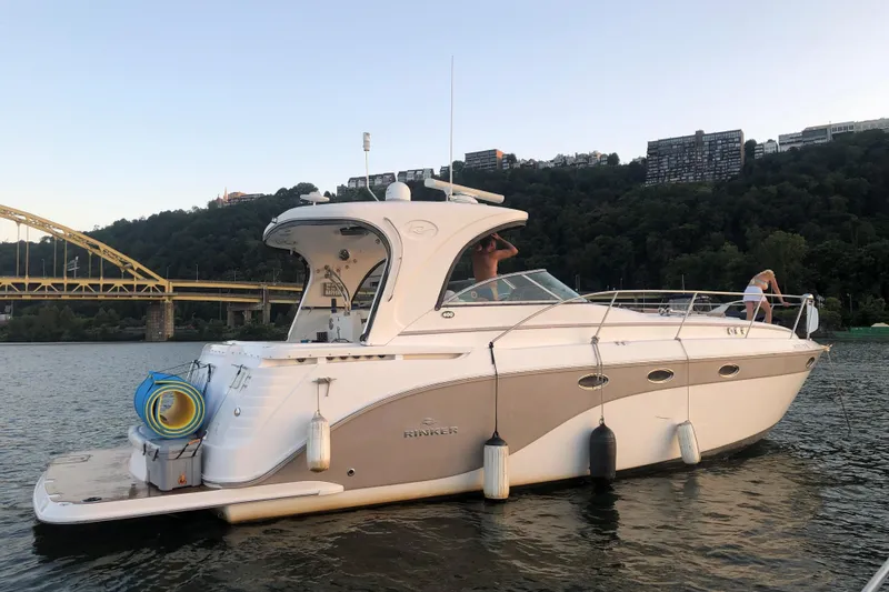  Yacht Photos Pics 2010 Rinker 400 Express Cruiser on a scenic river with a bridge backdrop.