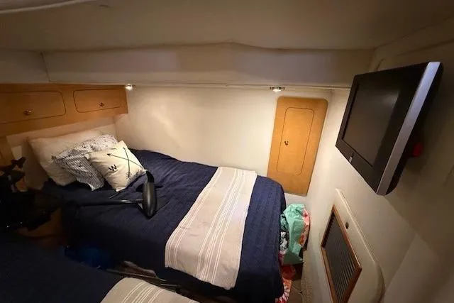  Yacht Photos Pics 2010 Rinker 400 Express Cruiser cabin with twin beds and wall-mounted TV.