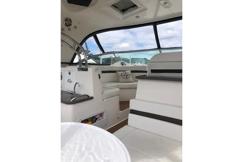  Yacht Photos Pics Interior of 2010 Rinker 400 Express Cruiser with white seating and modern design.