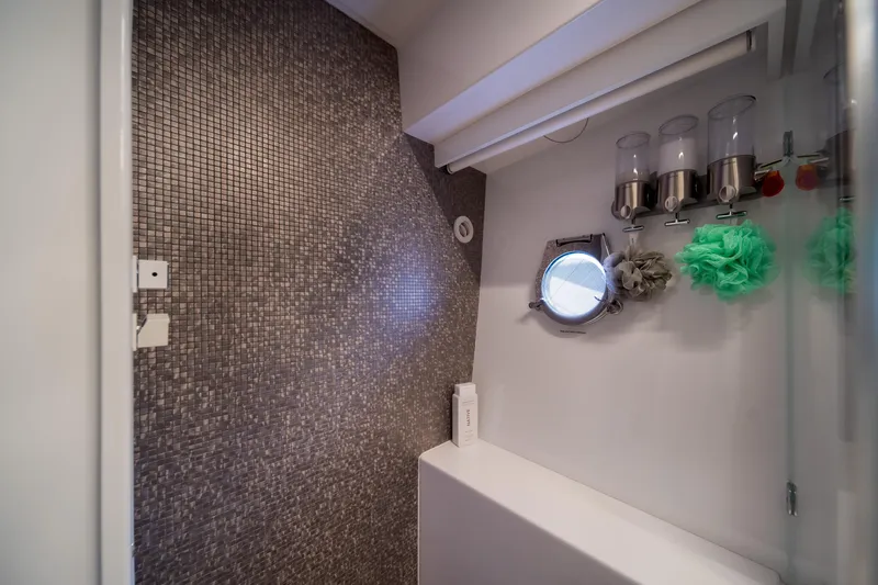  Yacht Photos Pics Luxurious bathroom in 2018 Ferretti Yachts 450 fly with mosaic tiles and porthole window.