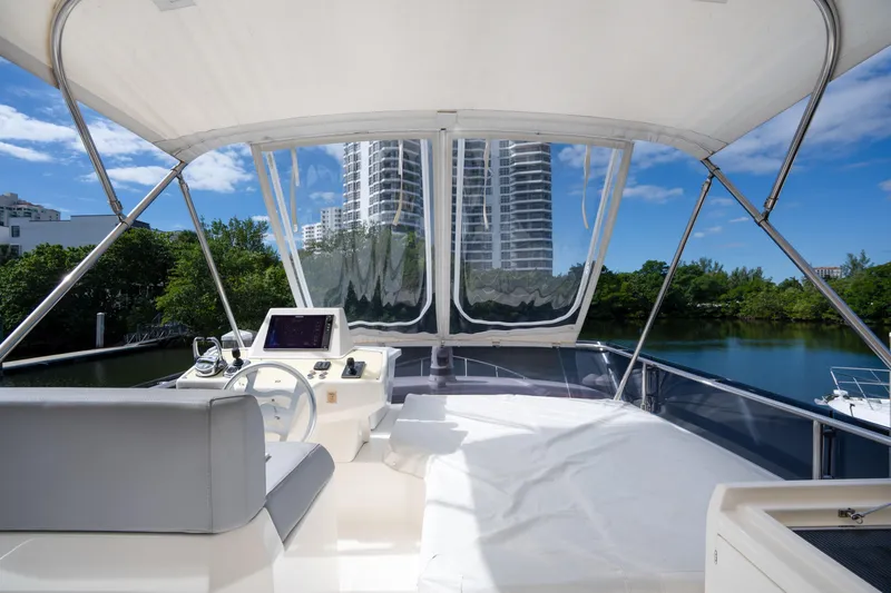  Yacht Photos Pics Flybridge view of 2018 Ferretti Yachts 450, featuring modern helm and scenic backdrop.