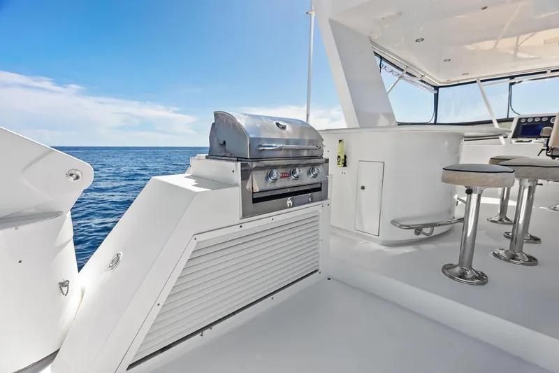 Bravo Zulu Yacht Photos Pics 1997 Westship Raised Pilothouse Motor Yacht deck with grill and seating, ocean view.