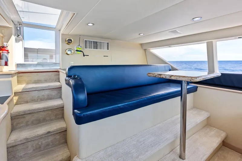 Bravo Zulu Yacht Photos Pics Interior of 1997 Westship Raised Pilothouse Motor Yacht with blue seating and ocean view.