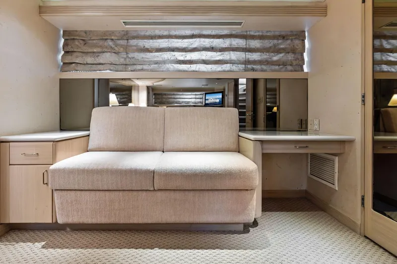 Bravo Zulu Yacht Photos Pics Luxurious interior of 1997 Westship Raised Pilothouse Motor Yacht with beige sofa and desk.