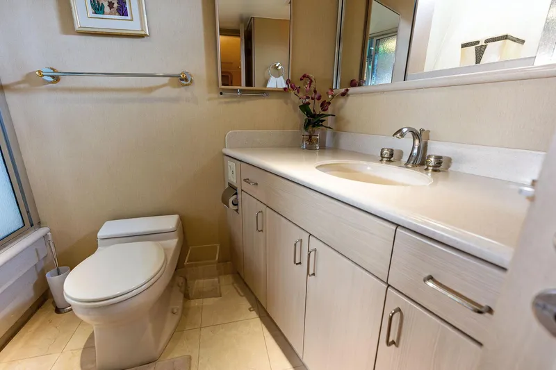 Bravo Zulu Yacht Photos Pics Luxurious bathroom in 1997 Westship Raised Pilothouse Motor Yacht with modern fixtures and elegant decor.