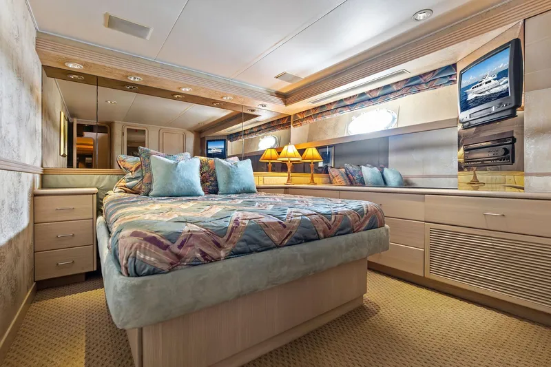 Bravo Zulu Yacht Photos Pics Luxurious bedroom interior of 1997 Westship Raised Pilothouse Motor Yacht with elegant decor.