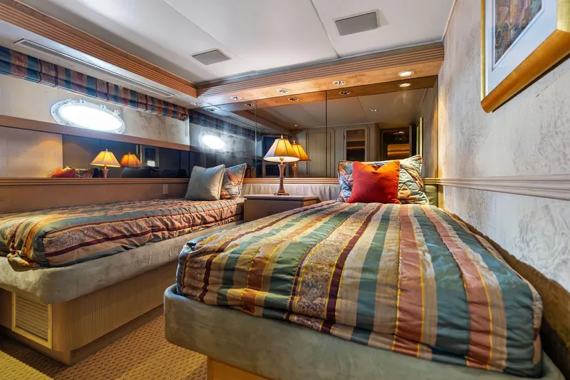 Bravo Zulu Yacht Photos Pics Luxurious twin bedroom in 1997 Westship Raised Pilothouse Motor Yacht, featuring elegant decor and ambient lighting.